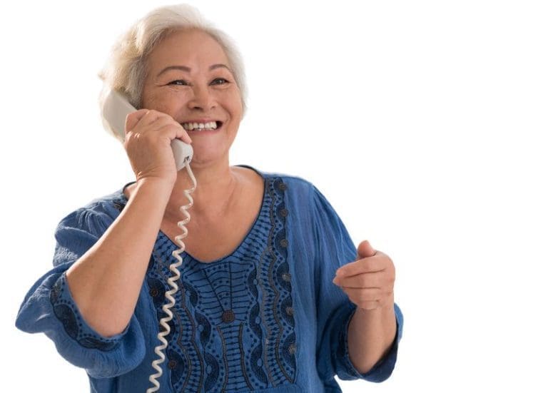 Senior Woman Talking on Landline Phone