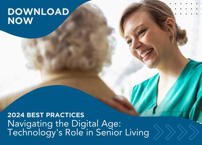Healthcare professional smiling and interacting with a senior resident in a well-lit care environment.