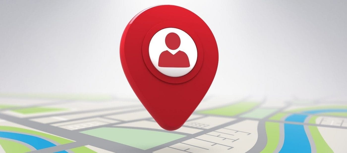 Red location pin with user icon on a stylized map