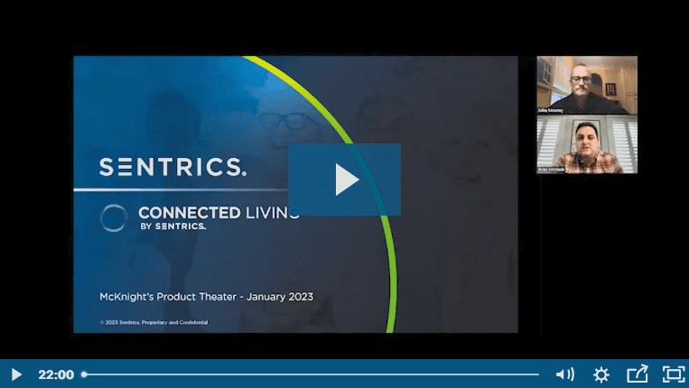 Video conference screen showing a Sentrics Connected Living presentation slide with two men in video call windows.
