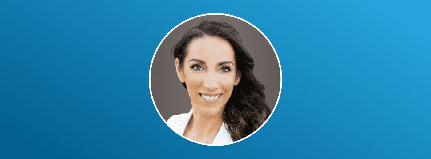 Amy Acosta smiling against a neutral and blue gradient background.